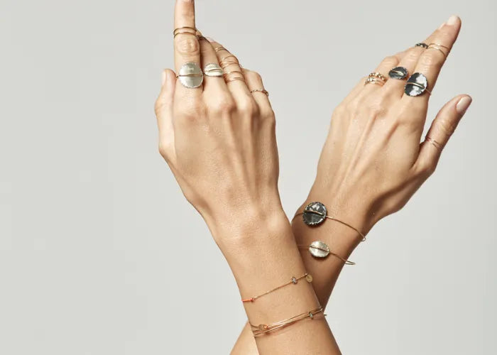 Femme portant une bague fil d’or et plateau argent noir Lsonge
